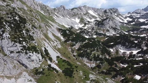Aerial drone view of different mountain peaks in the spring still with snow Stock Footage 221581216