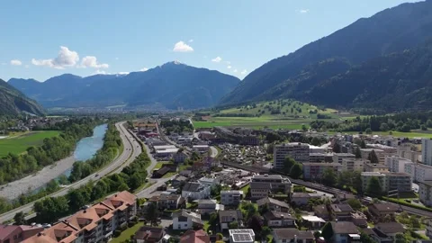 Aerial drone view of Domat Ems, Switzerland, showing the town, nearby river Stock Footage 335945123