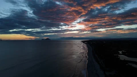 Aerial drone view of dramatic beach coastline at sunset in New Zealand Stock Footage 330522889