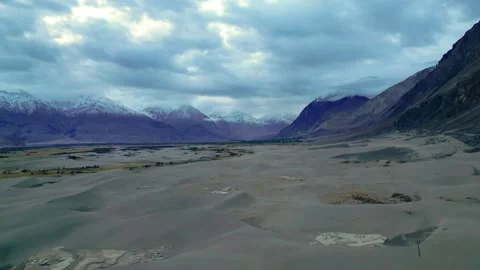 Aerial drone view of dramatic clouds casting shadows over the sand dunes of Stock Footage 310807003