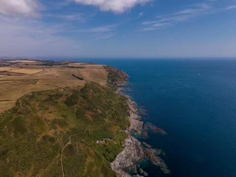 Aerial drone view of the dramatic coastline cliffs and shoreline Stock Photos