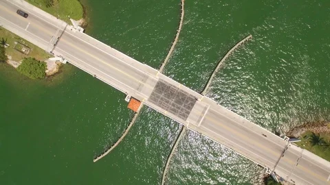 Aerial drone view of draw bridge road with car, boat and jetski traffic Stock Footage 100865903