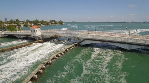 Aerial drone view of draw bridge road with car, boat and jetski traffic Stock Footage 100882902