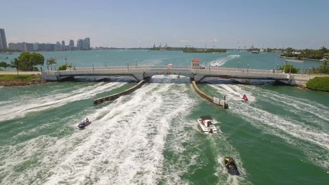 Aerial drone view of draw bridge road with jetski traffic near Miami Beach Stock Footage 100882922