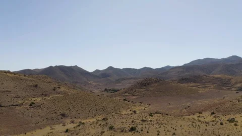 Aerial Drone view of dry empty spanish desert with vegetation and mountains in 動画素材 119351042