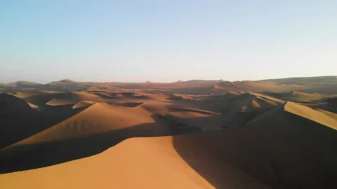 Aerial drone view of dry endless desert landscape at sunset Stock Footage 144454782