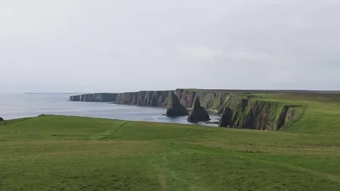 Aerial drone view Duncansby Stacks' dramatic cliffs rise over North Sea. Stock Footage 304605586