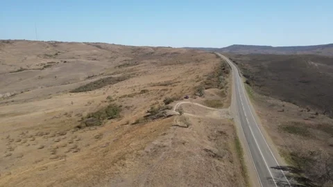 Aerial drone view of an empty road in a vast arid landscape Stock Footage 337479294