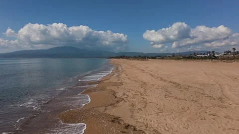 Aerial Drone View of Empty Sandy Beach and Calm Sea Under Dramatic Clouds Stock-Footage 330959946