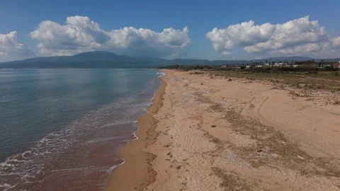 Aerial Drone View of Empty Sandy Beach and Calm Sea With Mountain Backdrop Stock-Footage 330960604