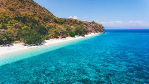Aerial drone view of an empty white sandy beach in tropical Moyo Island 스톡 사진