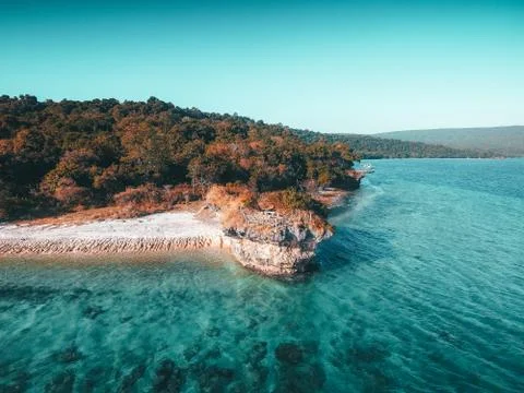 Aerial drone view of an empty white sandy beach in tropical Moyo Island Stock Photos