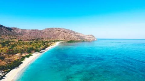 Aerial drone view of an empty white sandy beach in tropical Sumbawa, Indonesia 스톡 사진