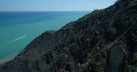 Aerial drone view of extinguished fire on hills by the sea 스톡 동영상 128294672