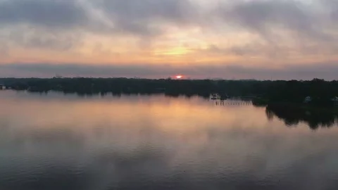 Aerial (drone) view of fast clouds and sunrise time lapse Stock Footage 137604210