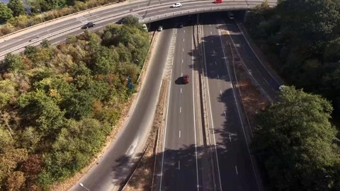 Aerial Drone View of Fast-Moving Cars at Sunny Road Overpass Stock Footage 341615134