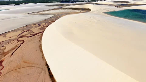 Aerial drone view of fine sand patterns on a white dune with reddish clay Stock Footage 344954021