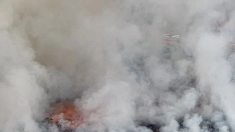 Aerial drone view of fire burning at landfill site Видео 332600221