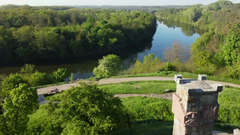 Aerial drone view flight over glade, bright green grass and stone old tower Stock Footage 154504957