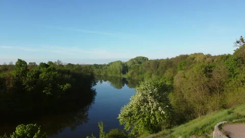 Aerial drone view flight over hill, slope. blue river, mirror reflecting surface Stock Footage 154505845