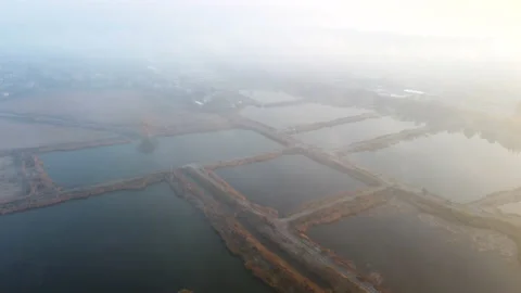Aerial Drone View Flight Over artificially dug ponds for fish farming autumn Stock Footage 165474193