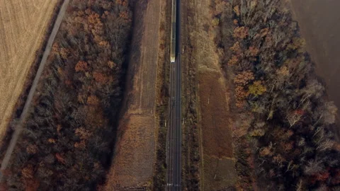 Aerial Drone View Flight Over train, which moves on railroad on autumn sunny day Stock Footage 169096767