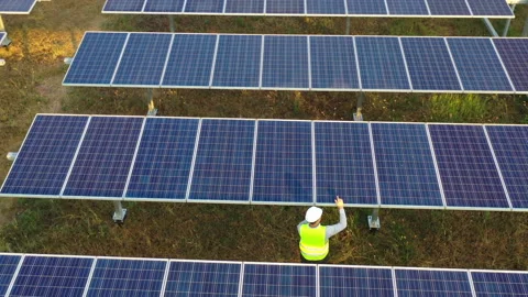 Aerial drone view, Flight over solar panel farm, young engineer talking  Stockbeeldmateriaal 198137548