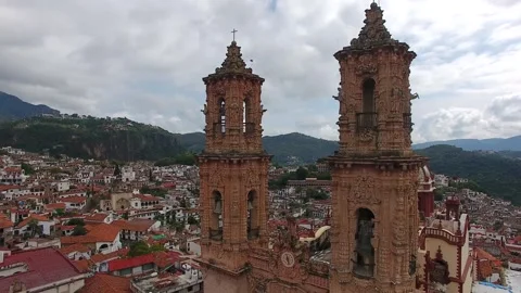 Aerial drone view flying backward from Santa Prisca Church. Stock Footage 337911794