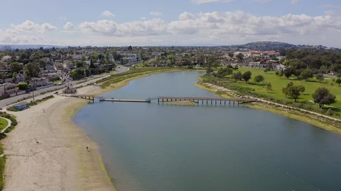 Aerial drone view flying backwards at Lagoon in Long Beach California Stock Footage 128995605