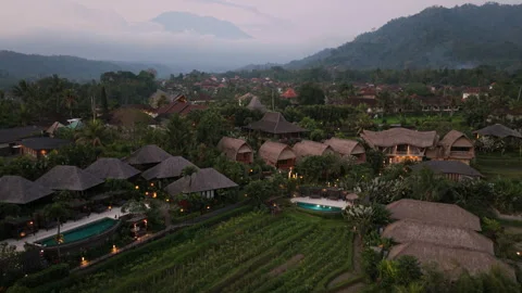 Aerial Drone View Flying Forward Over Luxury Eco Hotel Resorts at Sunset Stock Footage 345622284