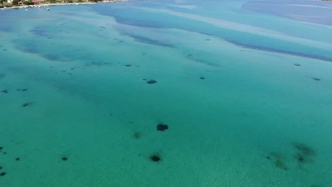 Aerial drone view, flying left slowly over blue turquoise water lagoon Stock Footage 91969035
