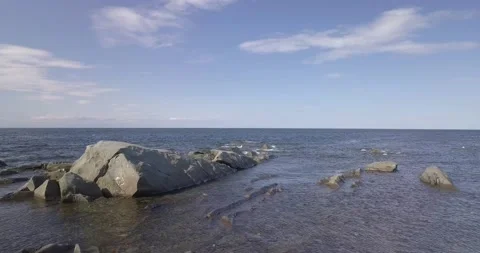 Aerial drone view flying mid-air over the sea, panning from left to right 動画素材 229916021