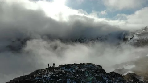 Aerial Drone View Flying Over Two People On the top of Peak in the Mountain Stock Footage