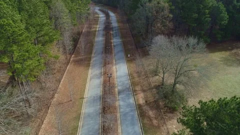 Aerial drone View Flying Over 2 Lane Street Park entrance Stock Footage 219030485