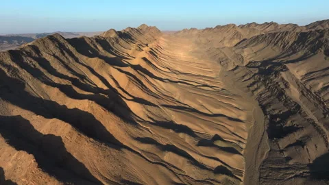 Aerial drone view flying over mountains in the desert at sunset. Stock Footage 308773608