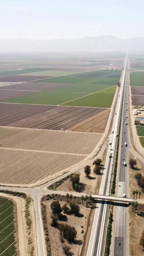 Aerial drone view flying over highway passing through vast Video stock 333159076