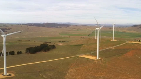 Aerial drone view flying through an array of large wind turbines Stock Footage 121093731