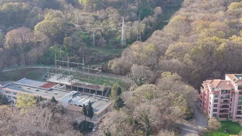 Aerial drone view of forest landscape with power lines and buildings Stock Footage 322537669