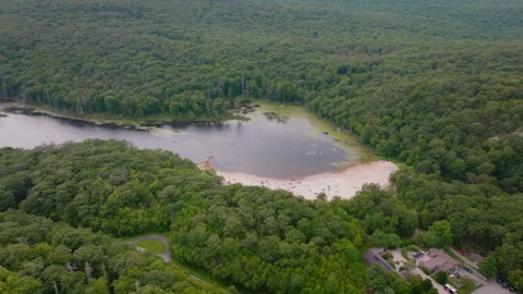 Aerial drone view of forest with sandy beach and lake in Peekskill New York Vídeo Stock 316038866
