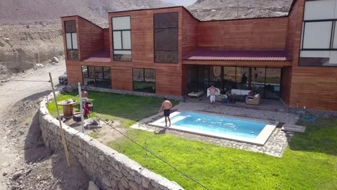Aerial drone view of friends in the pool and grilling on vacation at a country h 库存影片 199635440