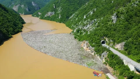 Aerial drone view of the garbage floating on the Drina river Stock Footage 264767243