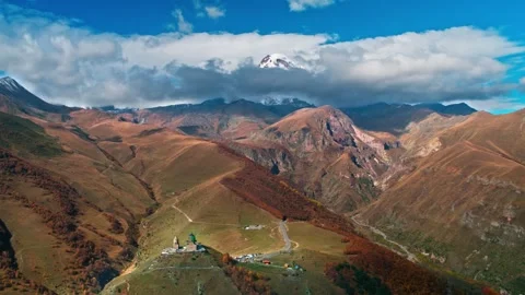 Aerial drone view of Gergeti Trinity Church with clouds over the mountain Stock Footage 304090360