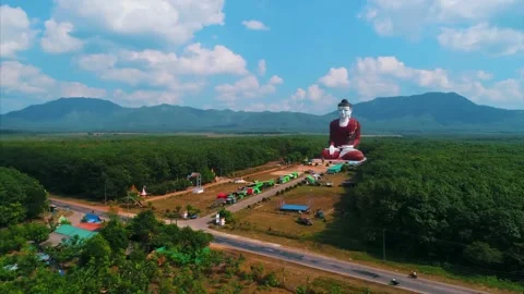 Aerial drone view of giant seated Buddha statue in Mon State, Myanmar Stock Footage 345545223