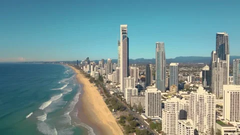 Premium stock video - Looking back at surfers paradise from water with drone