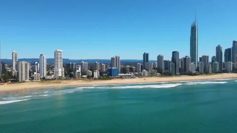 Premium stock video - Looking back at surfers paradise from water with drone