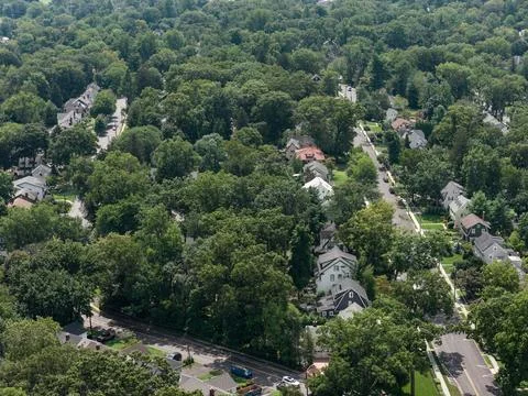 Aerial drone view of golf course fairways, nearby homes, and mature trees in Bay Stock Photos