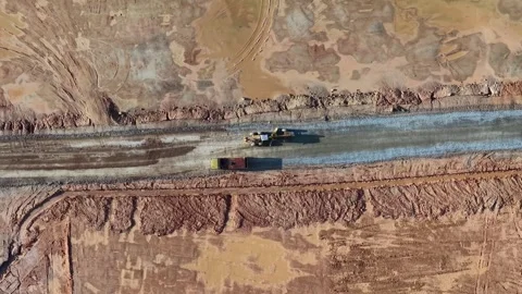 Aerial drone view of grader and dump truck preparing road Stock Footage 341384741