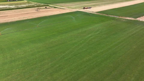 AERIAL: Drone view of grassfields growing alongside already harvested sod fields Stock Footage 268767454