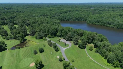 Aerial Drone View of a Green Golf Course Next to Burke Lake, Virginia Stock Footage 341295884