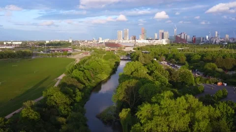 Aerial drone view of Hackney Marshes and view of London city skyline Stock Footage 155073061